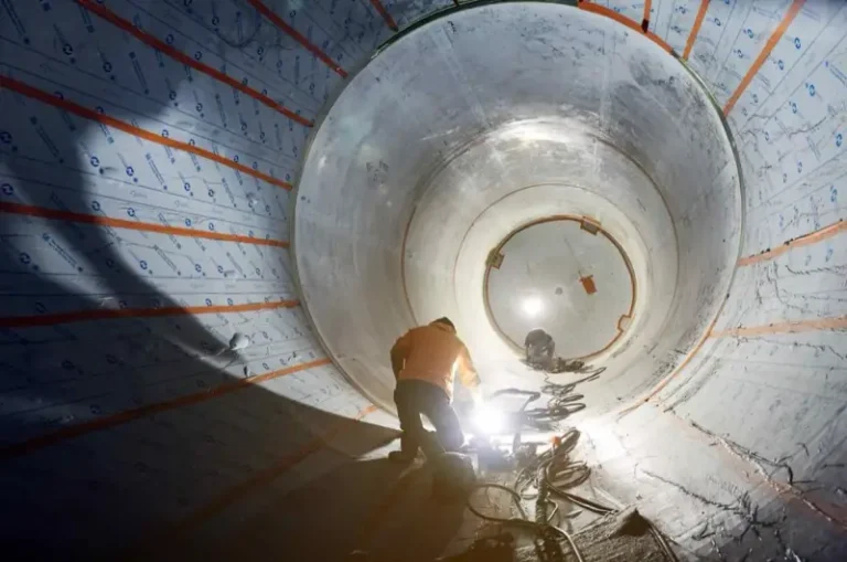 Watson crew polishing and finishing the interior of a large stainless steel tank