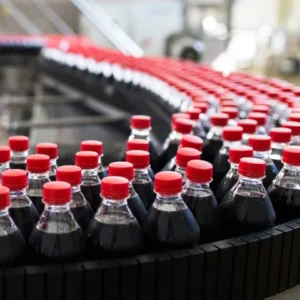Coca-Cola bottles moving down a beverage bottling line