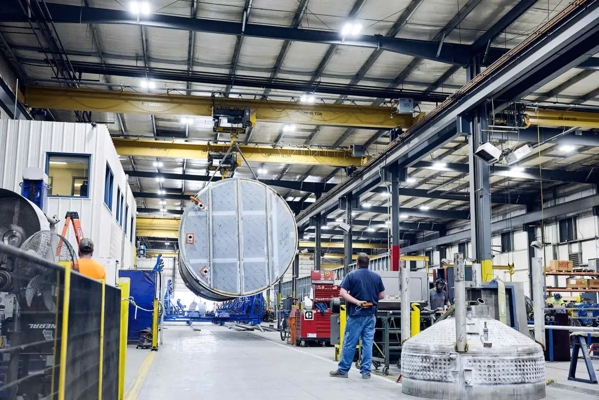 Watson fabricators assembling a custom stainless steel tank under the overhead cranes in the Springfield, MO shop